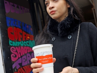 Milk campaign advertisement on a hot coffee sleeve